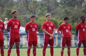 FNU men's soccer players lined up before the start of a game.