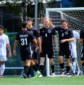 Ricardo Delwing celebrating with his team after a goal.