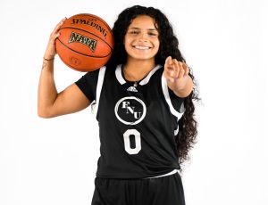 FNU women's basketball player Jullie Ruiz Paneto holding a basketball.